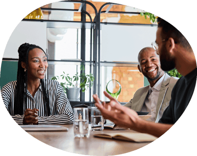 Three individuals engaged in conversation while seated at a table.