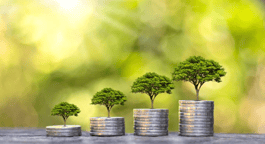 A group of coins with green trees growing from them