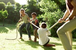 a group of people playing tug of war