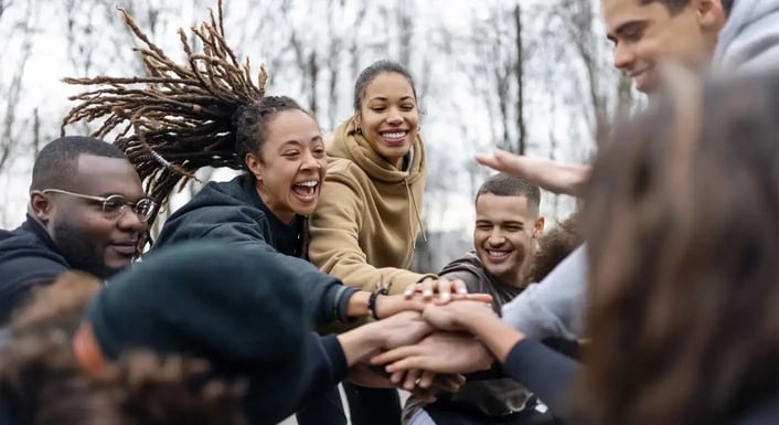 A diverse group of individuals holding hands in unity