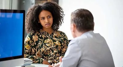 a person sitting at a table with a person