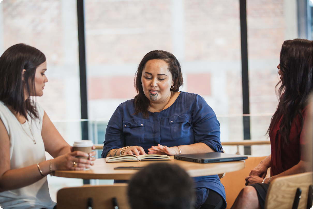 A group of people sit around a table sharing ideas