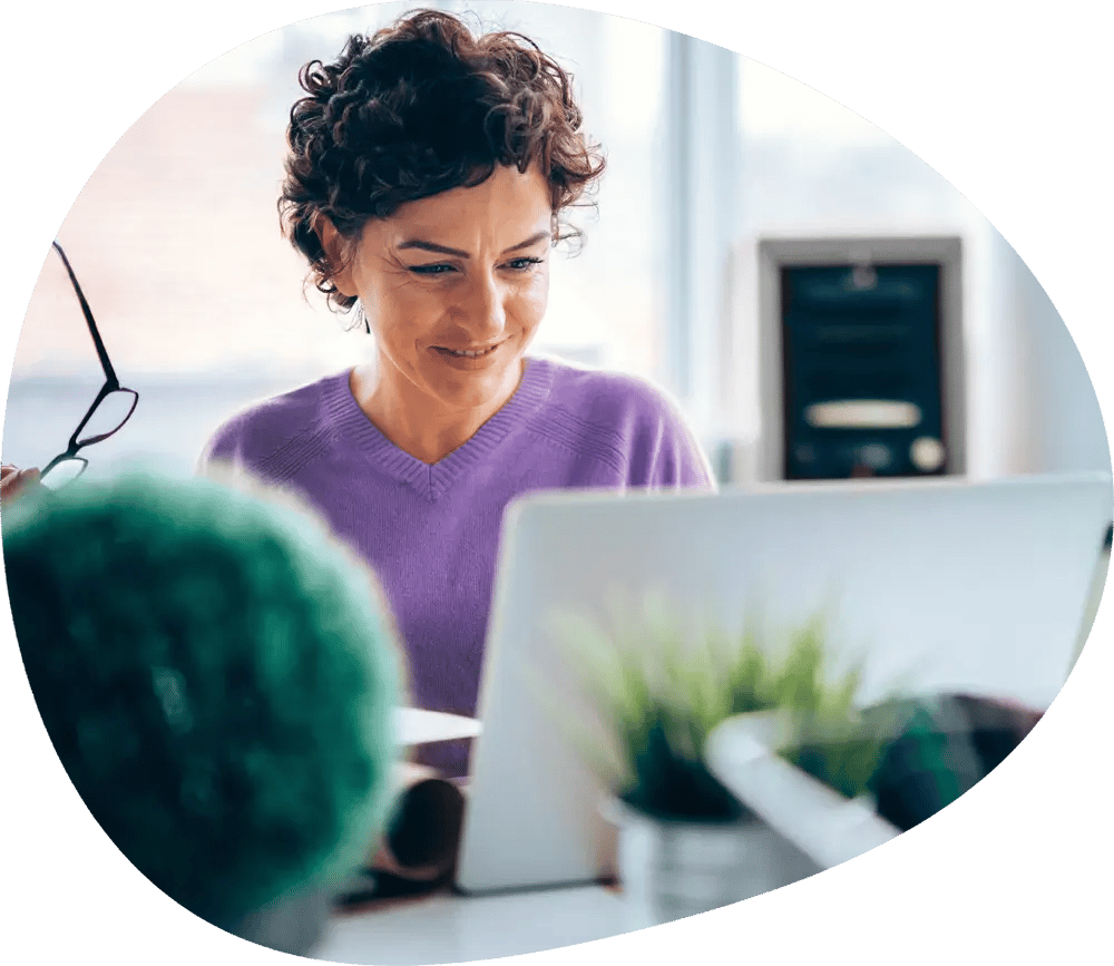 a person in purple shirt looking at a laptop a person in purple shirt looking at a laptop