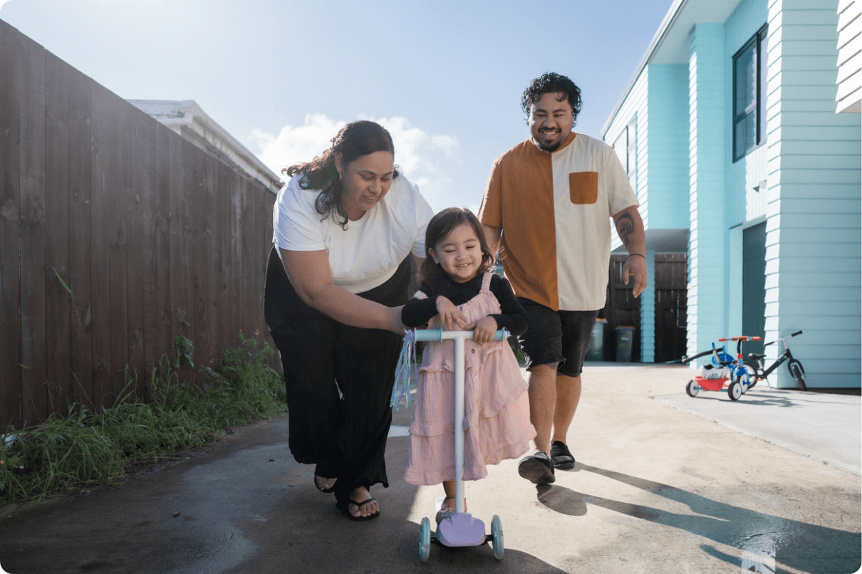 Father and mother playing outside with their daughter(1)