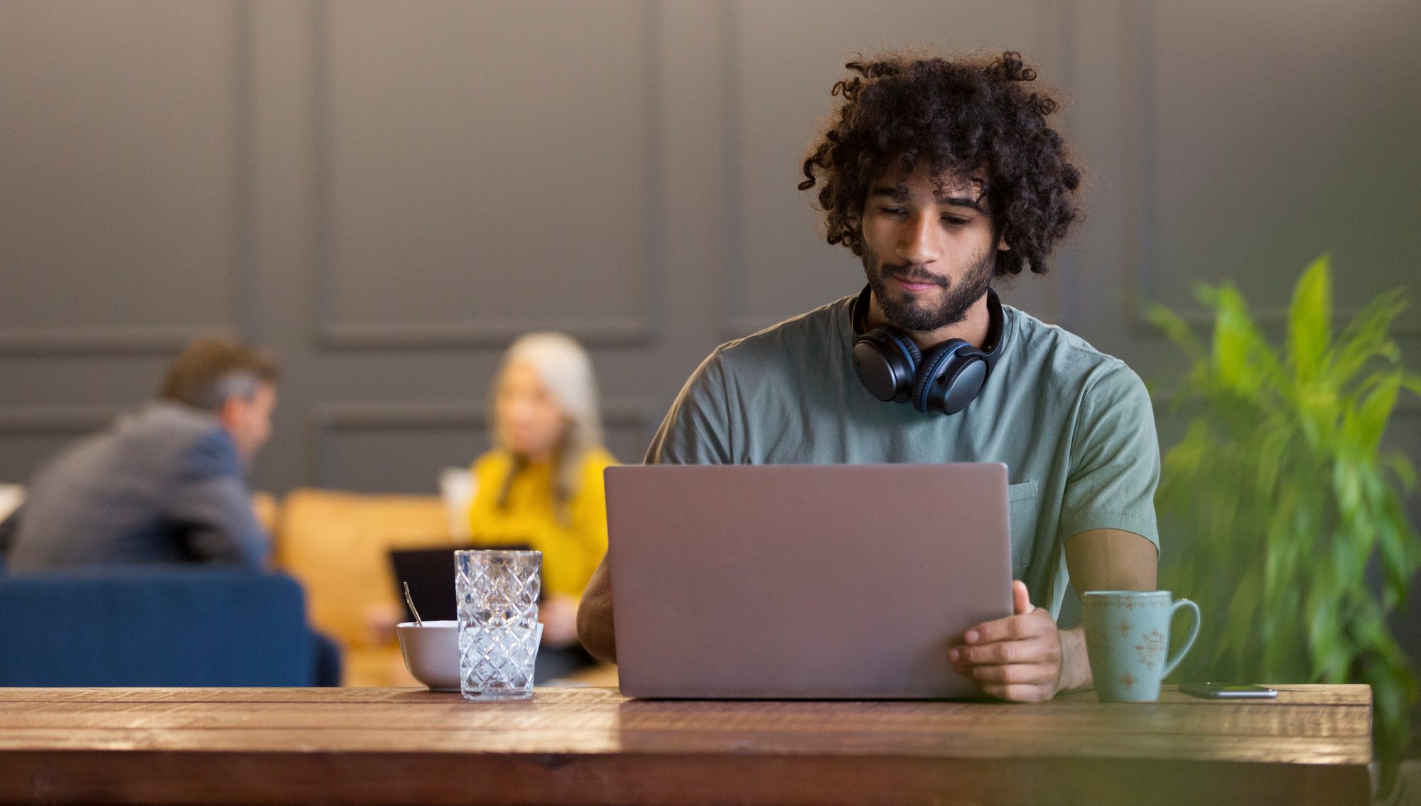 A young man sitting and using his laptop