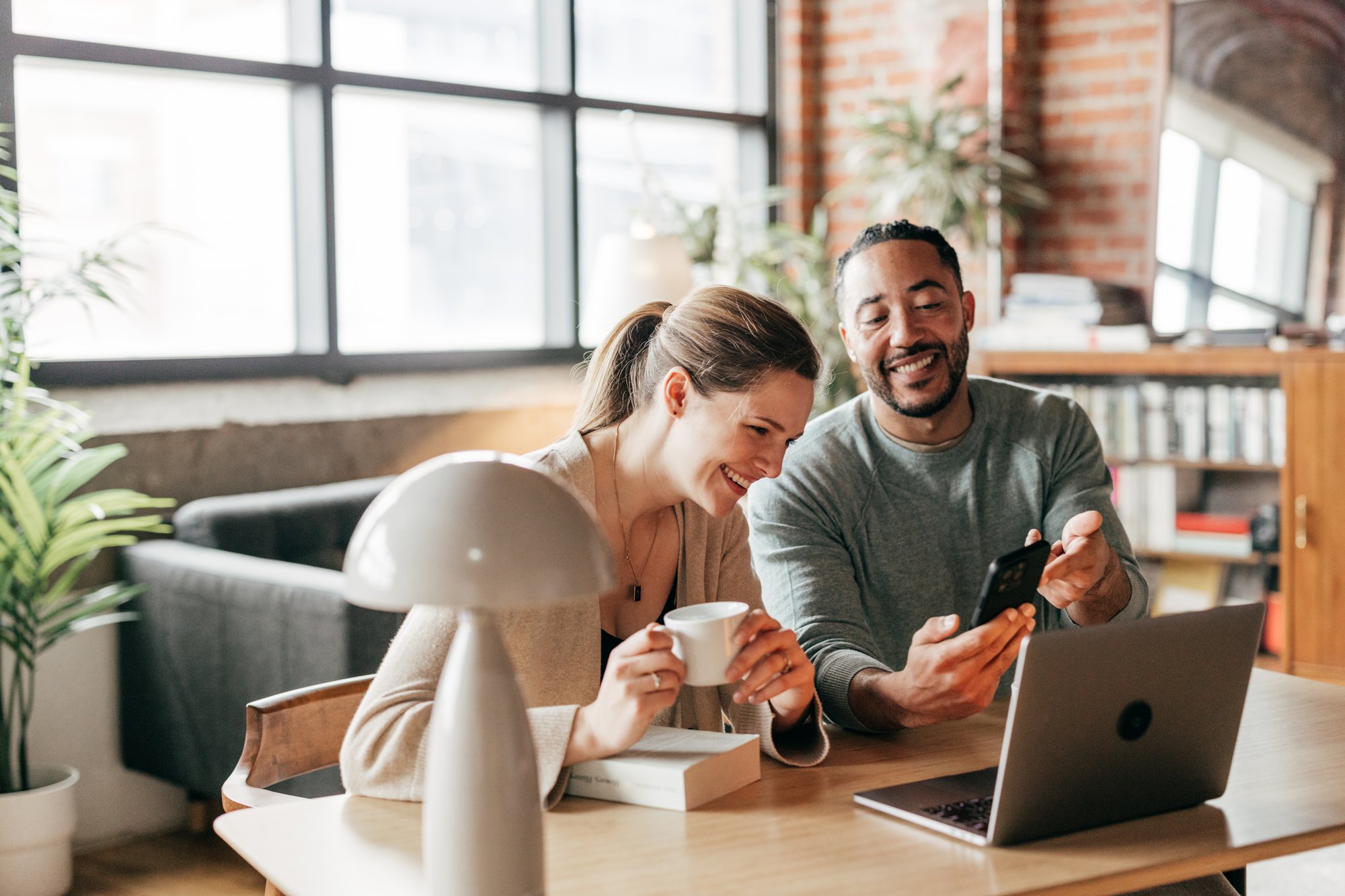 Couple in a virtual meeting talking to a laptop