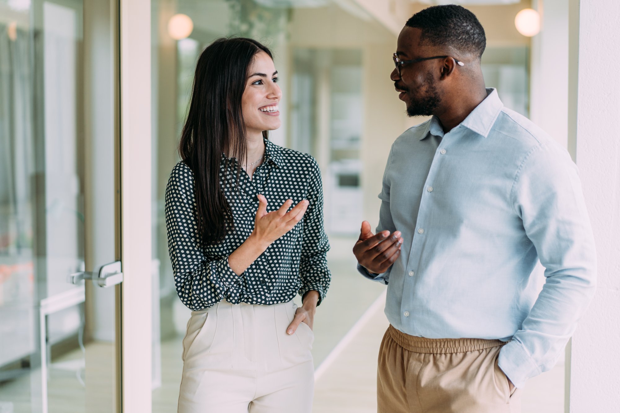 Two people talking in work clothes