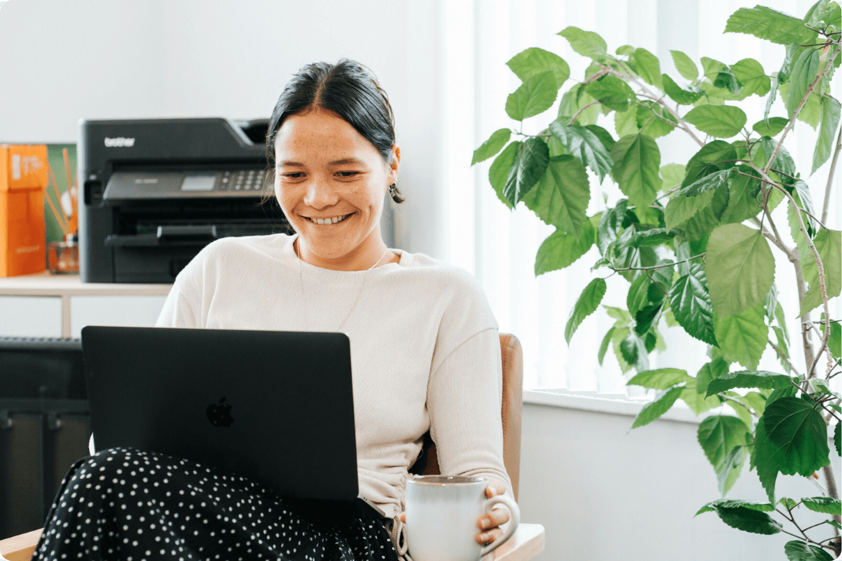 Woman working on laptop while drinking a cup of tea (1)
