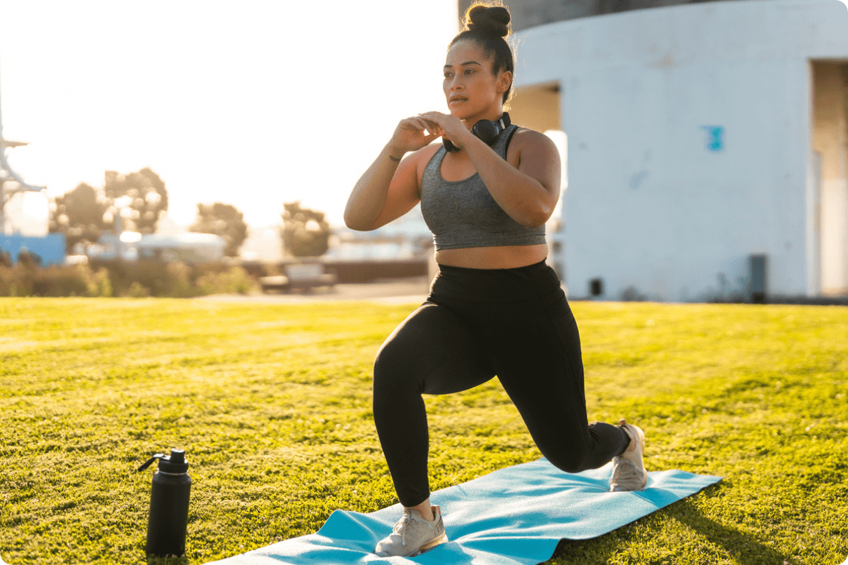Women in casual clothing practicing yoga outdoor on exercise mat (1)