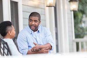 Two people sitting outside