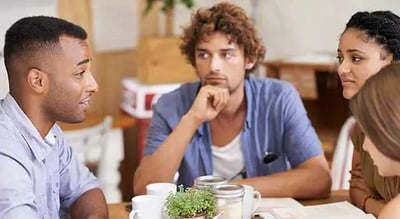 a group of people sitting at a table