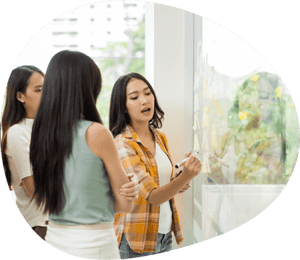 a group of women looking at a glass board