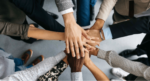 team of people holding hands