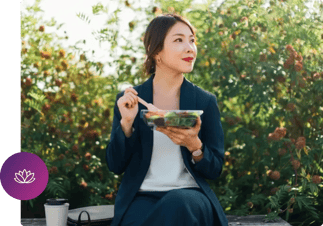 a person sitting on a bench eating a salad