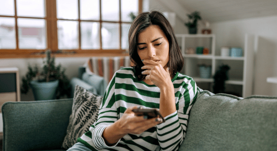 Woman sitting on couch, appearing concerned