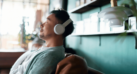 Person wearing headphones and resting with eyes closed
