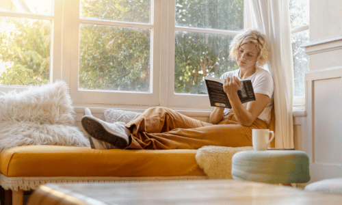 Woman reading a book on a sofa