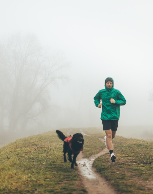 Active young man jogging with his dog