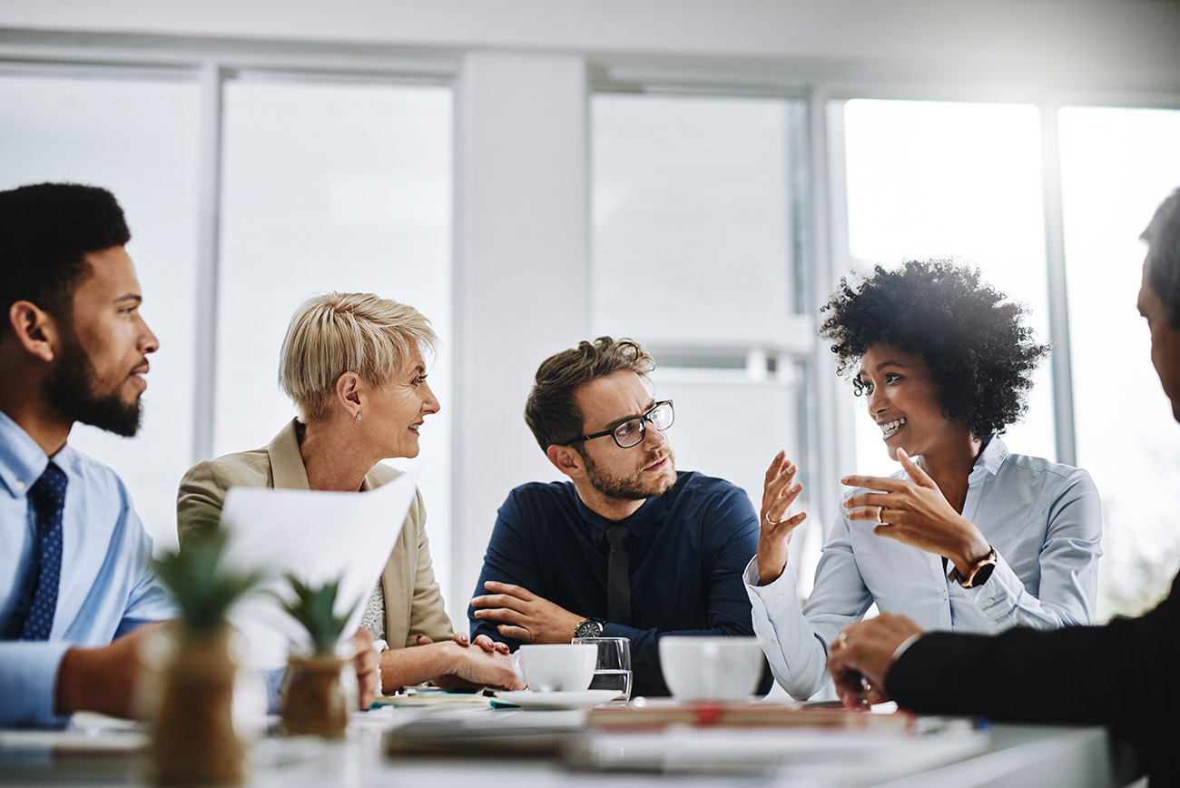 A group of employees sitting in a meeting room