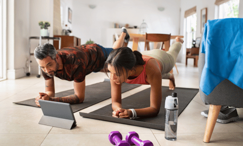 Man and woman practicing stretching exercise at home