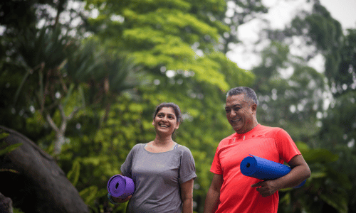 Mature man and woman exercising outdoors