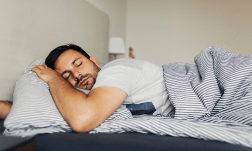 man sleeping in bed