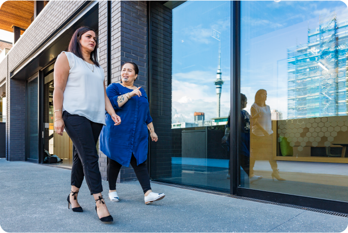 Two female coworkers walking outside